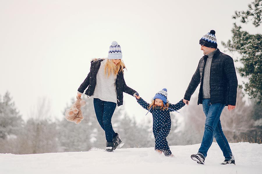 Personal Insurance - Family Walking through the Snow Holding Hands, Mom Holding Child's Teddy Bear